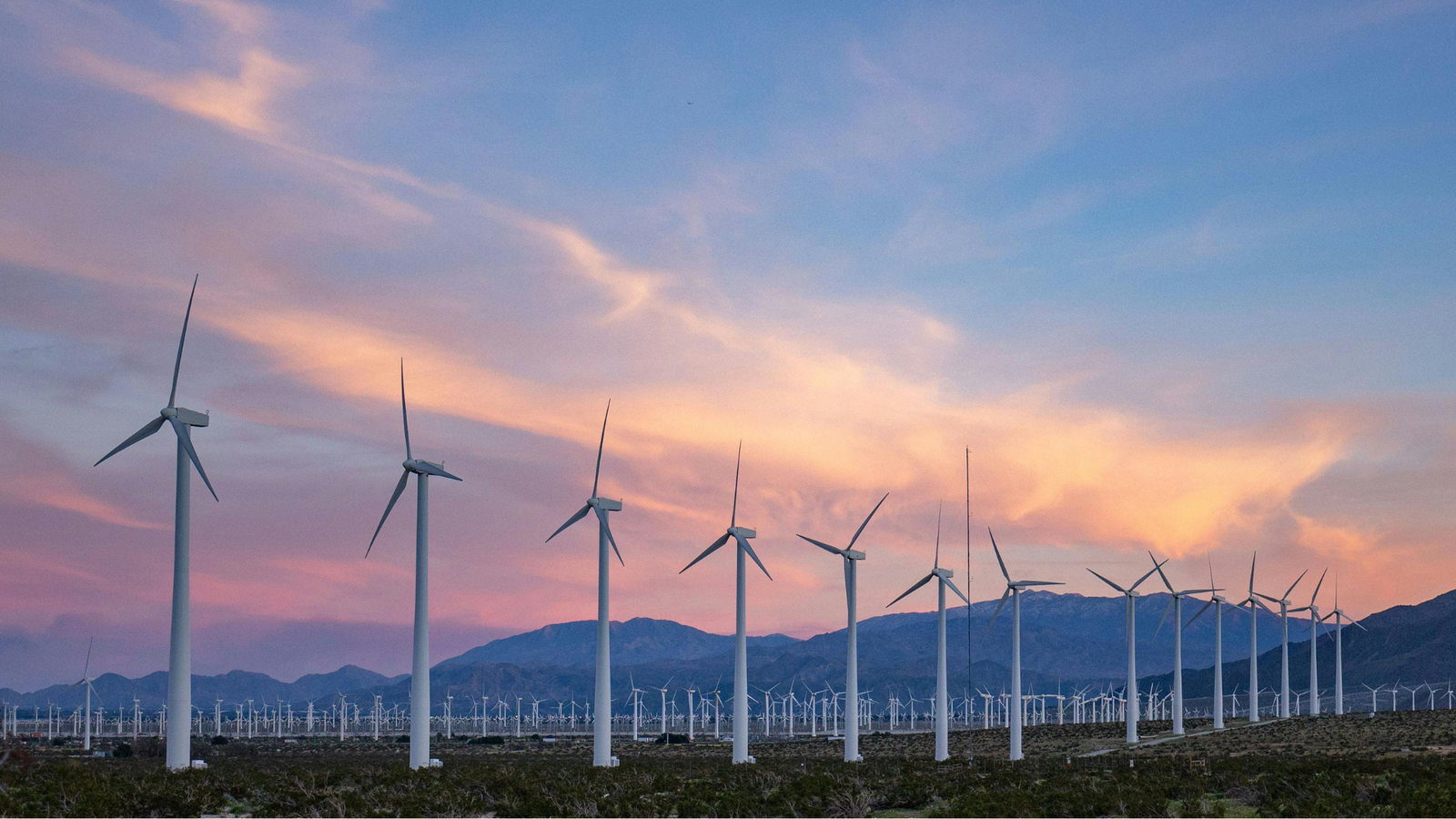 Wind power plants with a background of mountains and sky