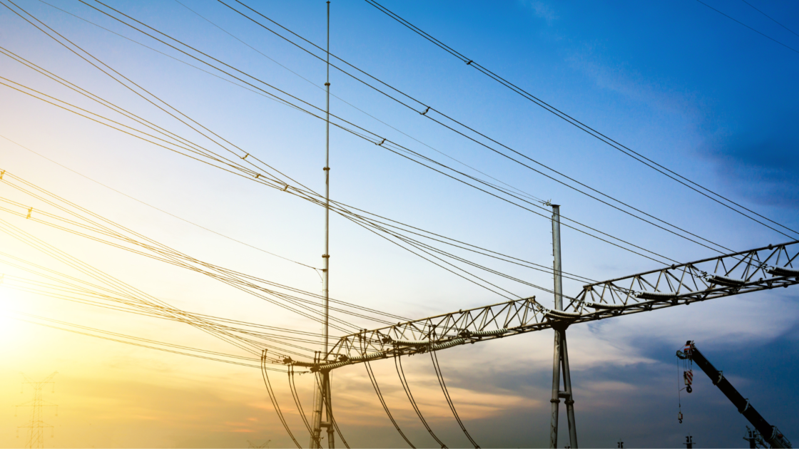 Sunset view of overhead power transmission lines and towers