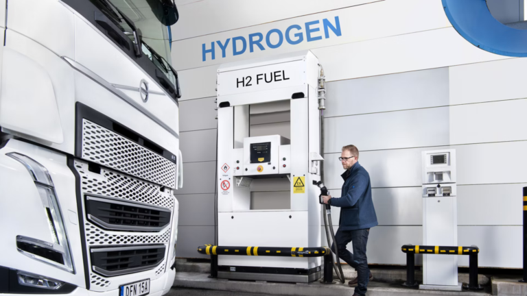 A hydrogen fuel cell truck being refuelled at an H2 fuel station