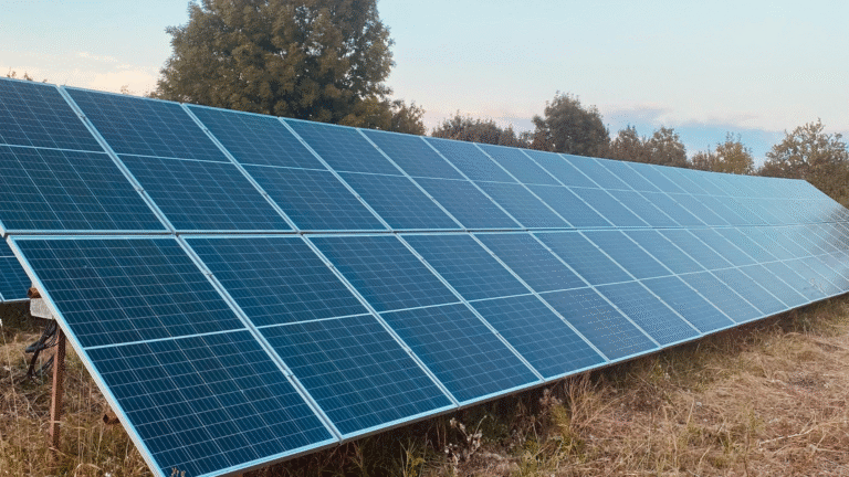 A solar panel with trees in background.