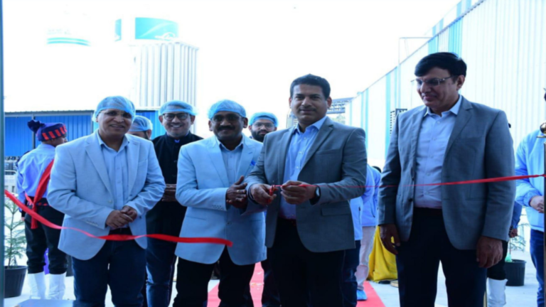 Senior officials from Fujiyama Power Systems and the Ministry of New and Renewable Energy during the inauguration of a 1 GW solar cell manufacturing plant at Dadri, Uttar Pradesh, with a ribbon cutting ceremony underway.