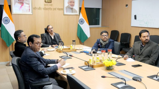 Officials from India’s Ministry of New and Renewable Energy hold a Joint Working Group meeting on renewable energy cooperation with Brazil, seated around a conference table with the Indian flag visible.