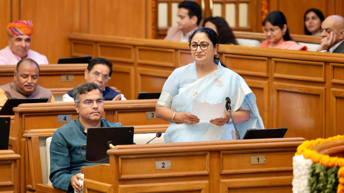 Delhi Chief Minister and Finance Minister Rekha Gupta presenting the 2026-27 Budget in the Delhi Assembly, addressing members during the session.