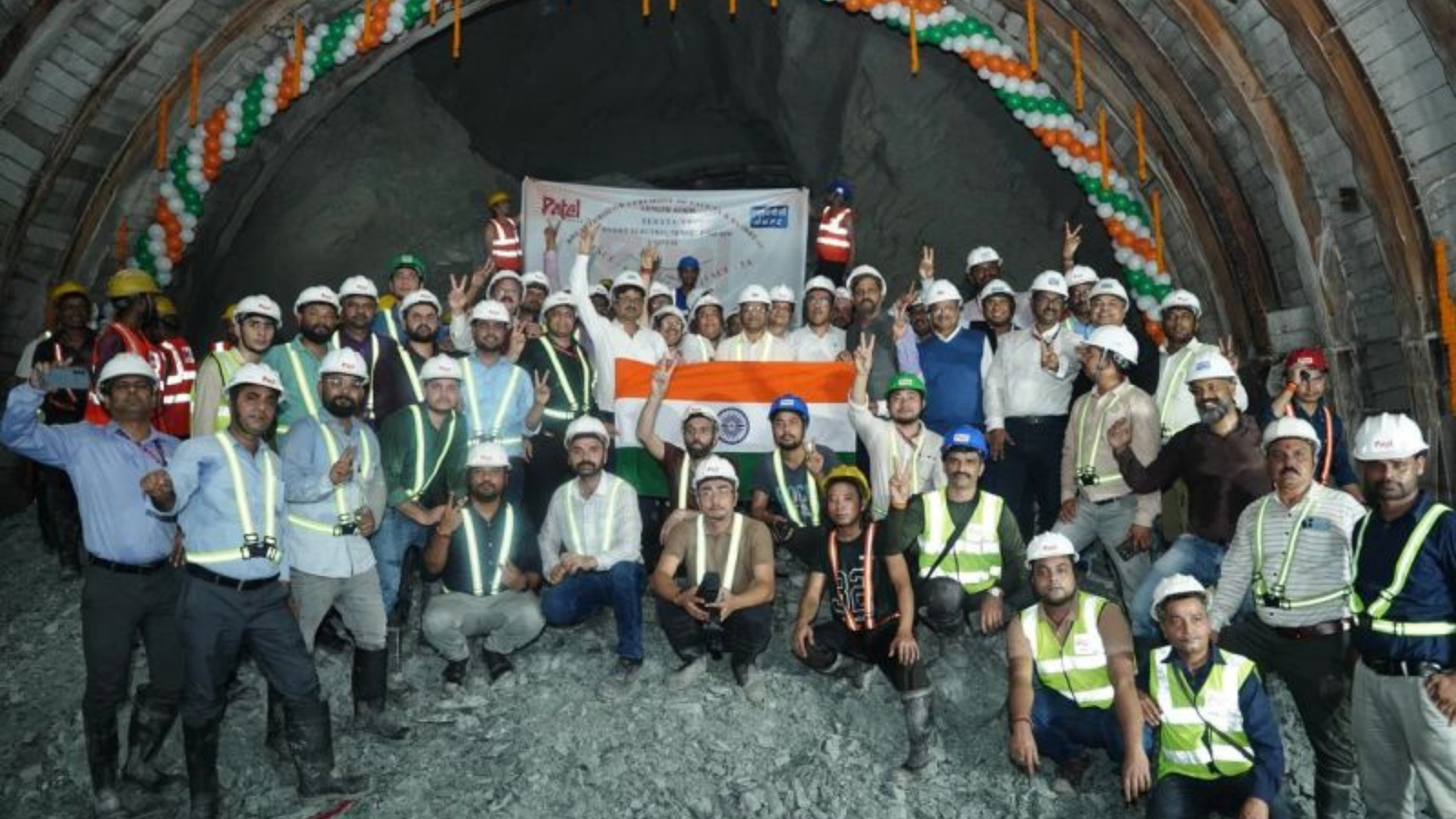 NHPC officials, engineers, and workers gather inside a tunnel holding the Indian flag to mark the March 27, 2026 breakthrough of Head Race Tunnel Phase-5A and 6A at the Teesta-VI Hydroelectric Project in Sikkim.