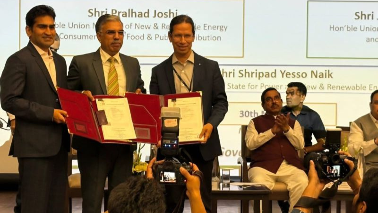 Officials display signed agreement documents during the signing of a Green Ammonia Purchase Agreement between NTPC Renewable Energy Limited and Solar Energy Corporation of India Limited under the National Green Hydrogen Mission.