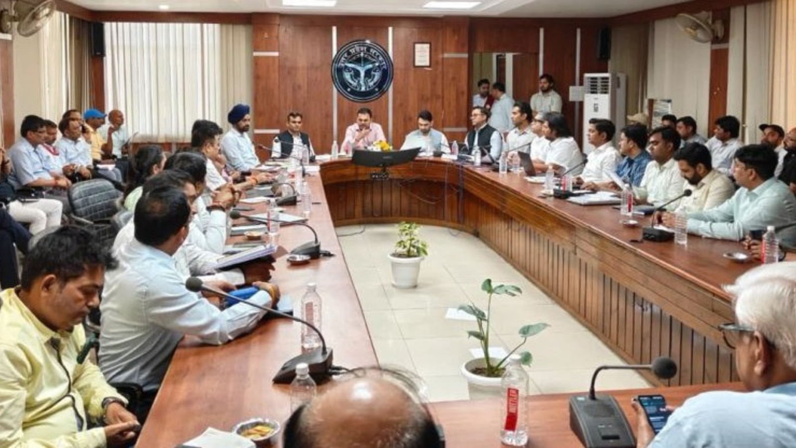 Officials and MNRE Mission Director J. V. N. Subramanyam chair a review meeting on PM Surya Ghar Muft Bijli Yojana implementation, with participants seated around a conference table in Uttar Pradesh.