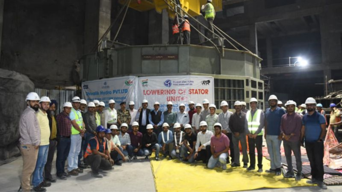 Workers and engineers pose at the Vishnugad-Pipalkoti Hydro Electric Project in Uttarakhand during the lowering of the fully assembled stator of Unit-1, marking a construction milestone on April 15.