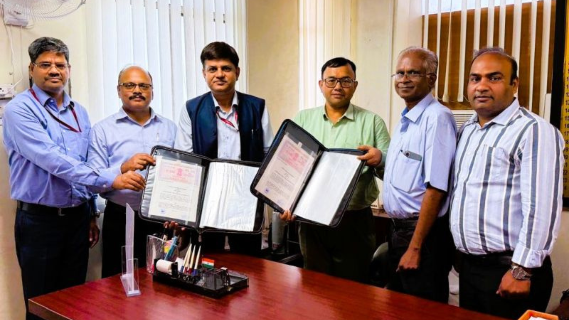 Officials from NHPC Limited and Uttar Pradesh Power Corporation Limited (UPPCL) display signed documents after executing a 40-year power purchase agreement (PPA) for electricity supply from the 260 MW Dulhasti Stage-II Hydroelectric Project in Jammu & Kashmir, at a signing ceremony in Lucknow on June 24, 2026.