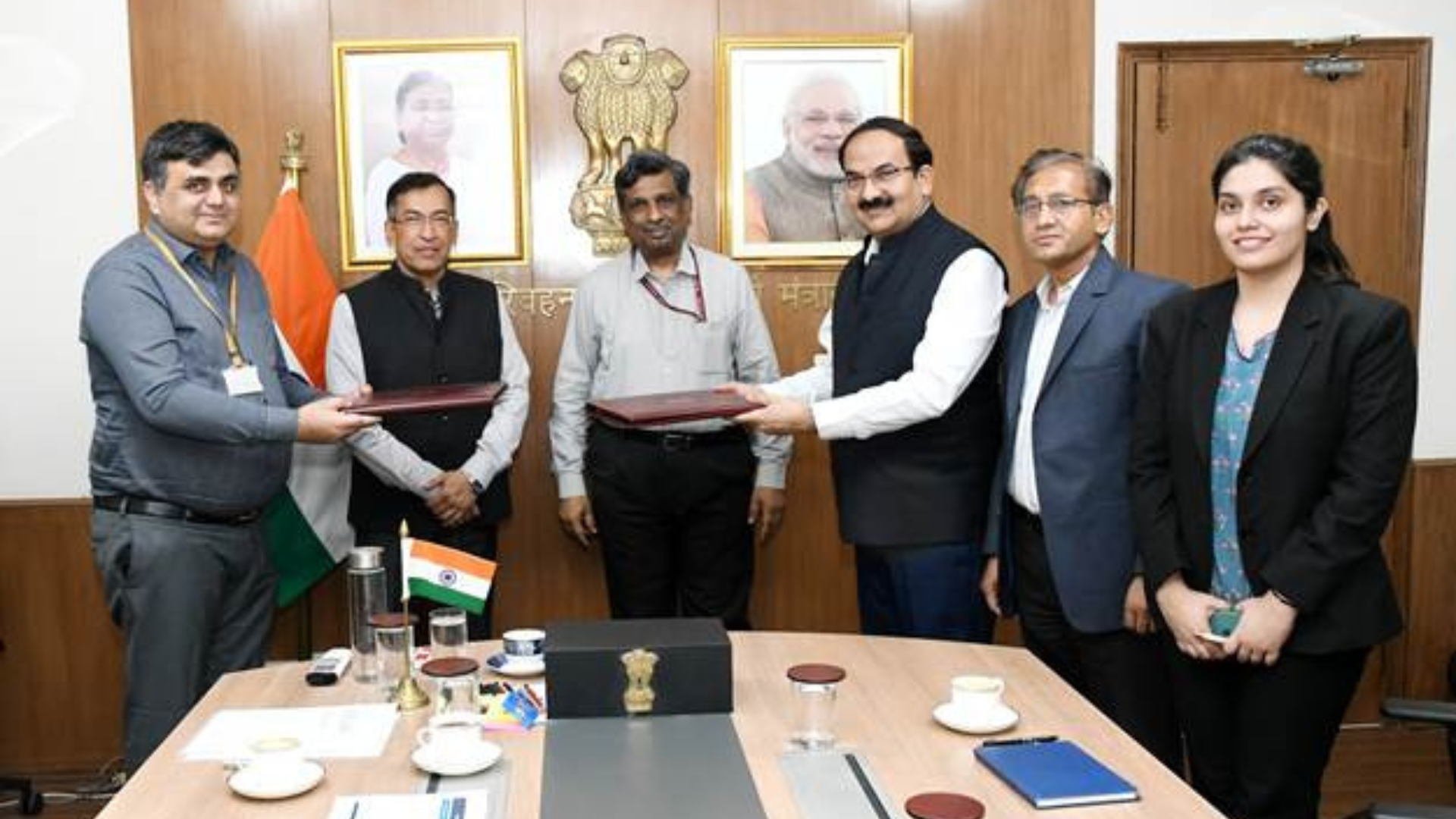 Officials from the Ministry of Road Transport and Highways, Ashok Leyland, and Switch Mobility exchange signed documents during the signing of the first MoU under the Delhi-NCR truck and bus replacement scheme in New Delhi.