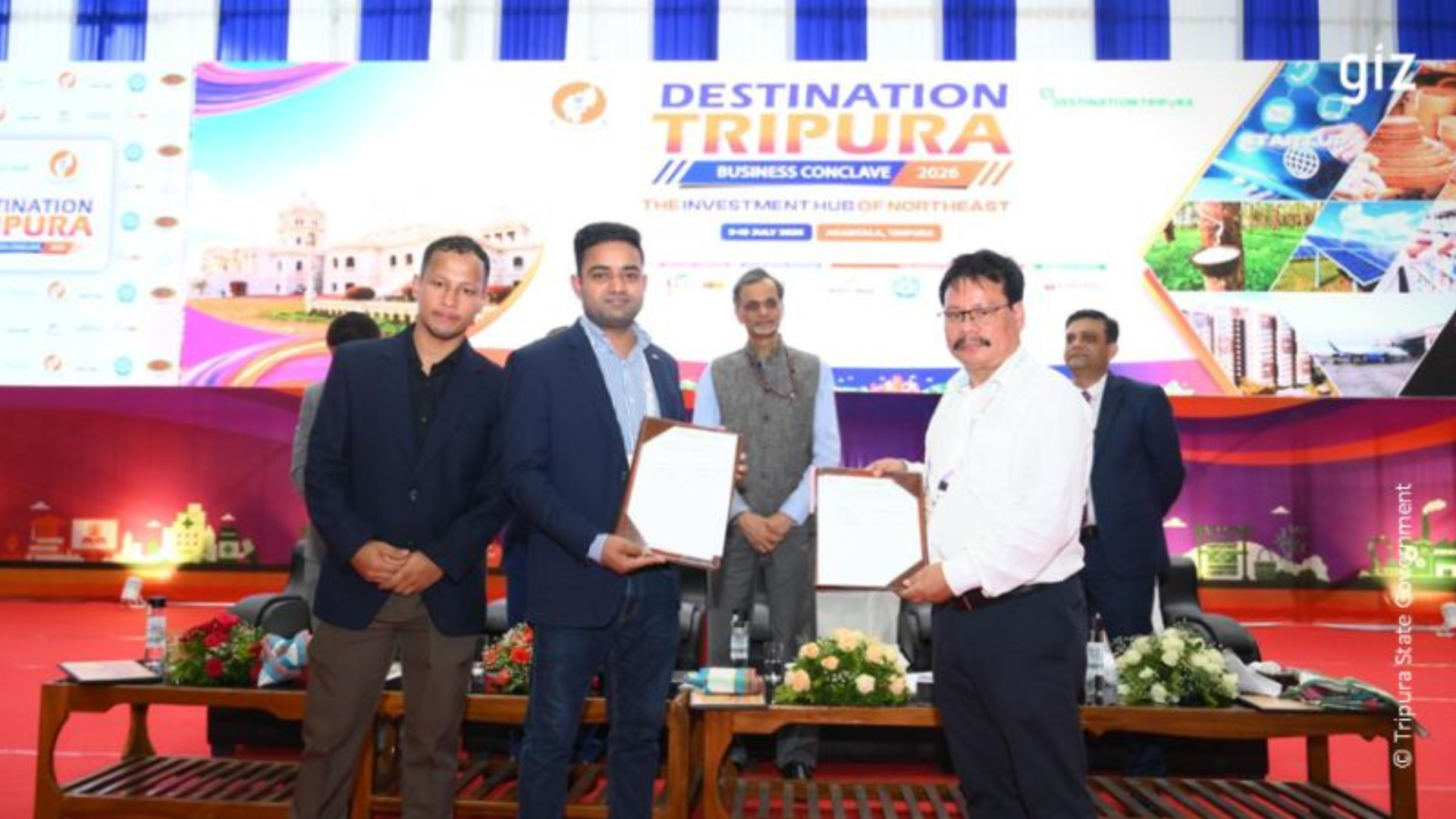 Representatives of GIZ India and Tripura government agencies exchange signed documents during the Destination Tripura Business Conclave 2026 in Agartala, marking the signing of a three-year clean energy partnership focused on renewable energy, PM Surya Ghar implementation and capacity building.
