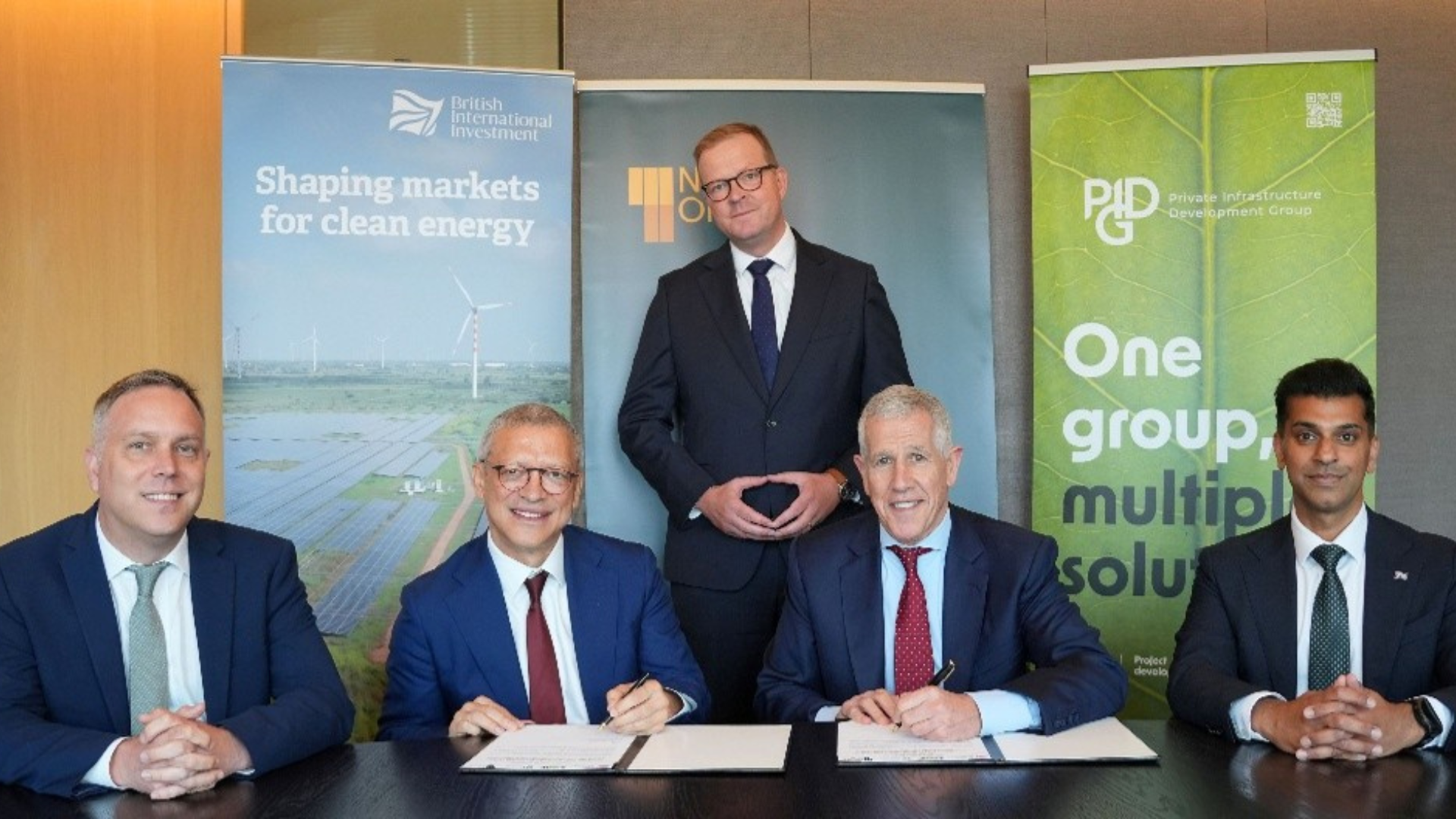 Signing ceremony to mark the partnership with EAAIF L-R: Phil Stevens (Director, FCDO), Leslie Maasdorp (CEO, BII), Hendrik du Toit (founder & CEO, Ninety One), Stephen Varma (Chief Risk Officer, PIDG), and standing is Martijn Proos (Co-Head of EM Alternative Credit, Ninety One).