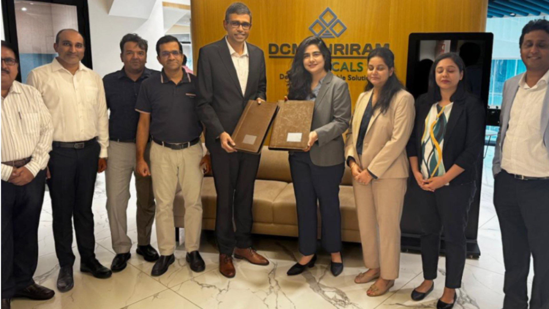 Group photograph of representatives from DCM Shriram Chemicals and Serentica Renewables during the signing of a renewable energy agreement at the DCM Shriram Chemicals office.