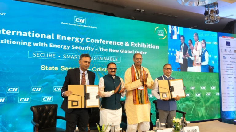 Odisha and Madhya Pradesh officials hold signed MoU documents during the 7th CII International Energy Conference and Exhibition in New Delhi.